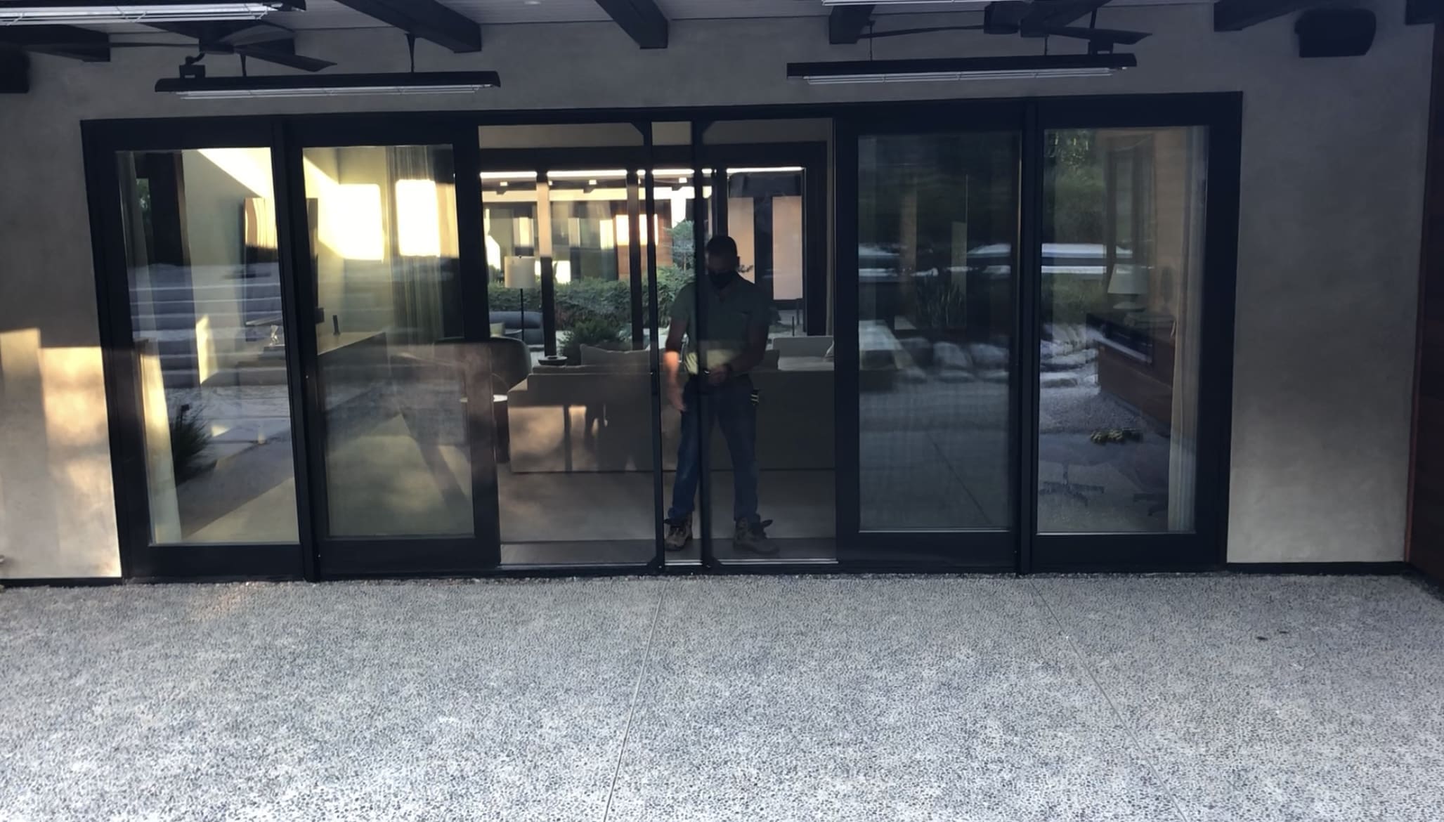 A person standing in front of a glass door.