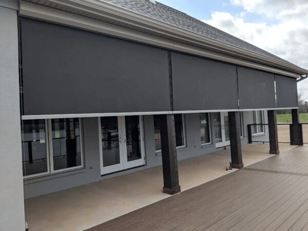 A building with several black awnings on the side of it.